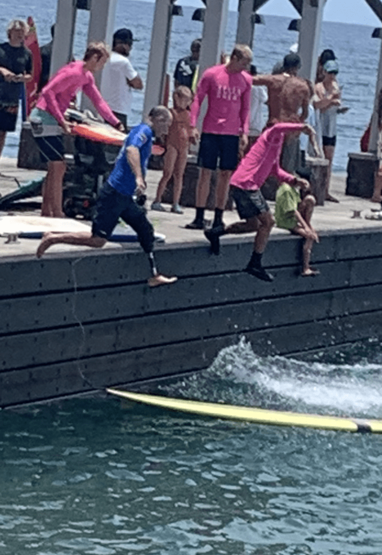 People Jumping Off of a Dock